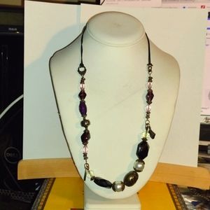 woman's necklace with the Bible in a cross and glass beads